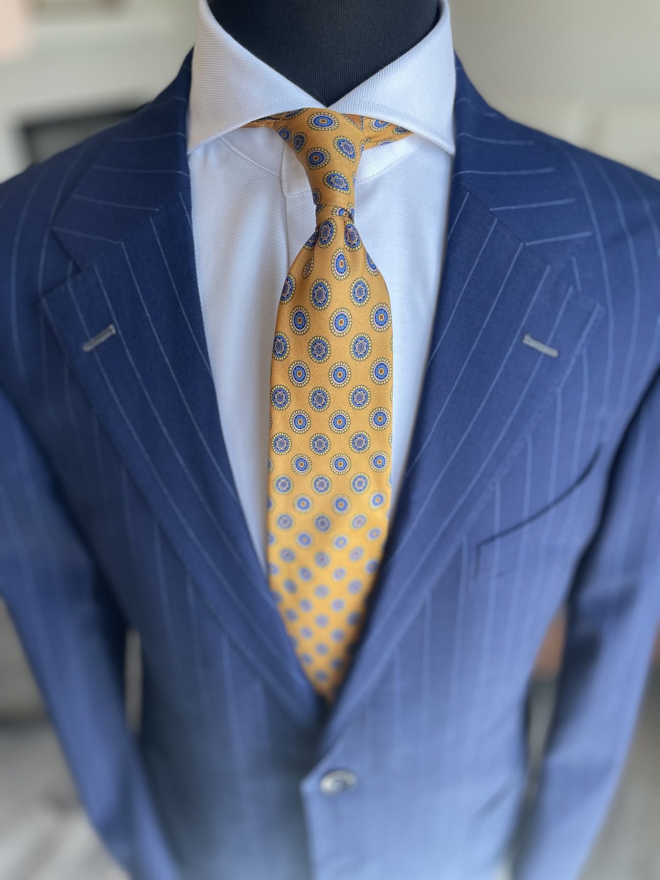 Blue pinstripe suit with gold patterned tie