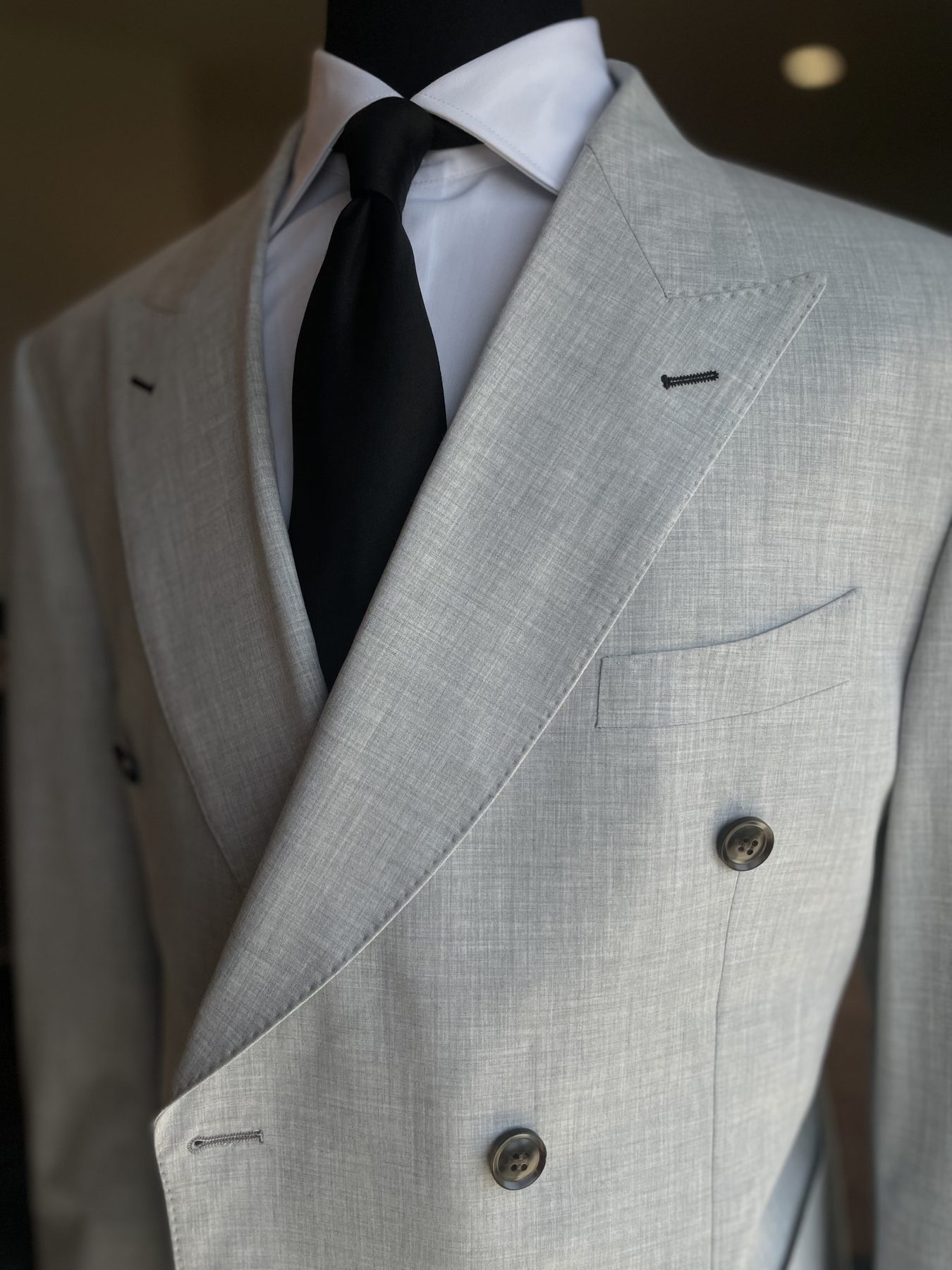 Light gray double-breasted suit with black tie
